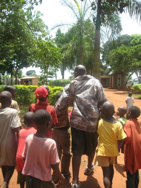 Seggy with kids at Nkumba