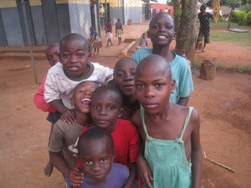 Isaac is the boy in the green overalls.  He is from Gulu, an area in Northern Uganda where Invisible Children is - they have several child soliders in this area.  Isaac's mom was a solider and recently died from AIDS.