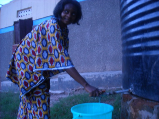 Justine gets water from the tank- June 2010