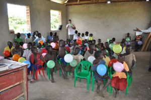 plastic chairs donated by some of the team members- this was the first time some children had ever sat in a chair